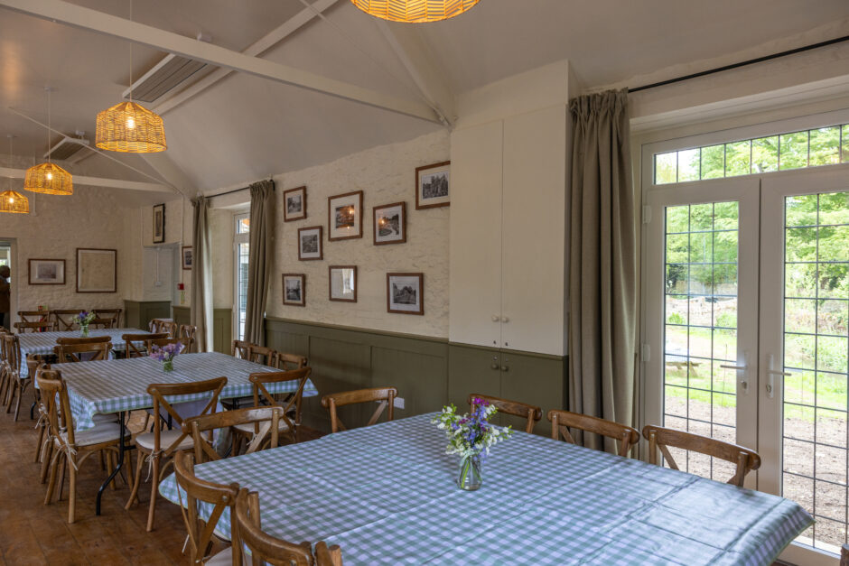 Inside the village hall with a picture of the chairs and tables and patio doors